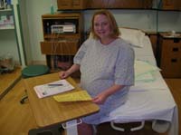 05-Kristi_in_her_hospital_gown_filling_out_paperwork