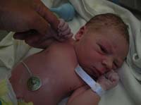 37-Kenny_holding_onto_Daddy's_finger_while_looking_at_camera