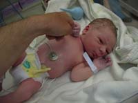 38-Kenny_holding_onto_Daddy's_finger_while_looking_at_camera