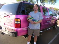 10-Chris_holding_Kenny_in_front_of_Pink_Suburban