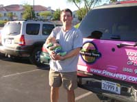 12-Chris_holding_Kenny_in_front_of_Pink_Suburban