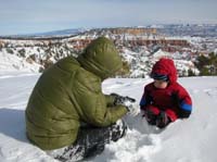 032-Mommy_trying_to_play_with_Kenny_in_snow_again