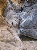 25-Daddy_going_up_class_III_slab_to_end_of_canyon