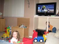 40-watching_Shrek_while_Kenny_climbs_on_the_stereo_equipment