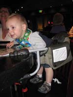 057-Kenny_standing_in_hook_on_highchair