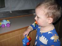 041-Kenny_playing_with_little_trucks_in_the_camper