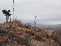 06-Daddy_checks_his_GPS,Kenny_points_at_the_airplane_on_the_top_of_Red_Mountain