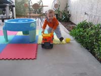 25-Kenny_playing_with_his_truck_in_the_backyard