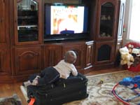 13-Kenny_using_the_suitcase_as_a_couch