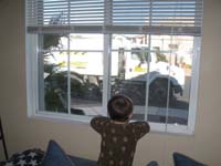 12-Kenny_watches_the_street_cleaner_truck_pass_by_the_house