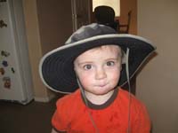 38-Kenny_wearing_Daddy's_hat-doesn't_look_too_big_on_him