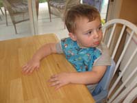 019-Kenny_sitting_at_the_table_like_a_big_boy_waiting_for_the_food