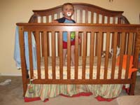 033-first_time_without_the_bumpers-look_how_big_he_is_standing_in_his_crib