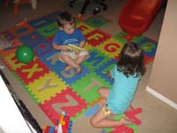 044-Kenny_shows_Sierra_his_alphabet_mat