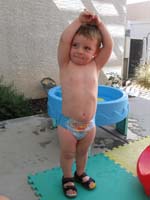 089-arms_up_high-Kenny_grew_two_inches_in_two_months-looks_thinner-less_belly