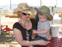08-Mommy_helping_Kenny_put_on_his_cowboy_hat_and_sheriff's_badge