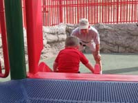 03-Grandpa_watching_Kenny_ride_down_the_slide