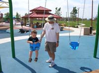18-Kenny_in_the_swing_while_Daddy_pushes