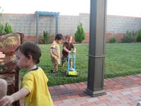 20-Kayhan_watches_Kenny_mow_the_lawn