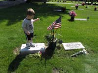 25-Kenny_standing_on_Great_Grandma_Bartlett's_grave_marker
