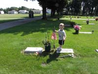 26-Kenny_standing_on_Great_Grandpa_Bartlett's_grave_marker