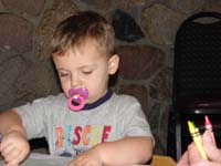 30-grumpy_Kenny_gets_to_suck_on_a_purple_pacifier_while_coloring