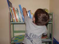 32-Kenny_picks_out_a_book_to_read_before_going_night_night