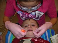 47-Kenny_laid_down_in_Daddy's_lap_backwards_while_his_teeth_were_polished