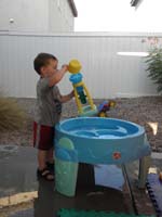 05-playing_with_his_water_table