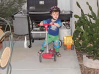22-Kenny_rides_his_scooter_in_the_backyard
