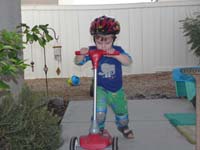 24-Kenny_rides_his_scooter_in_the_backyard