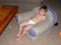 77-after_a_hard_days_work_Kenny_chills_on_the_couch_watching_TV