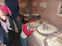 05-Kenny_using_a_mano_and_metate_to_grind_corn_like_the_Indians