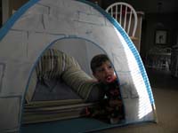 27-Kenny_watching_a_video_from_his_tent