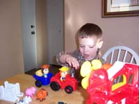 02-Kenny_playing_with_his_new_farm_toy