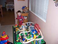 32-Kenny_plays_with_his_new_train_table