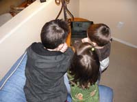 14-Toby_Sierra_Kenny_huddle_around_the_little_TV_to_watch_'Up'