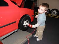 25-Kenny_changes_the_tire-watch_out_he_has_a_power_drill