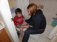 25-Mommy_reads_to_Kenny_while_he_tries_to_go_potty