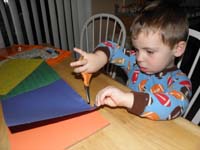 36-Kenny_using_scissors_to_cut_paper