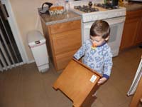17-Kenny_carries_the_heavy_stool_back_to_the_bathroom