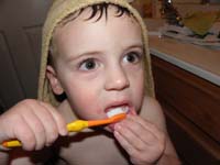 19-Kenny_brushes_his_bottom_teeth-pulls_down_his_lip
