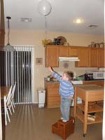 39-smart_kid_using_the_stool_to_reach_his_balloon_stuck_on_the_ceiling