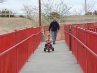 64-Poppy_trying_to_chase_after_Kenny_on_his_big_wheel