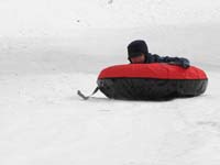 63-sequence_photos_of_Kenny_tubing_down_the_hill