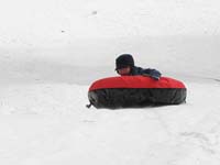 64-sequence_photos_of_Kenny_tubing_down_the_hill