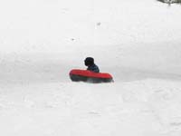 71-sequence_photos_of_Kenny_tubing_down_the_hill