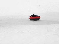 75-sequence_photos_of_Kenny_tubing_down_the_hill-gets-a_bit_of_air