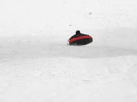 76-sequence_photos_of_Kenny_tubing_down_the_hill-still_having_fun