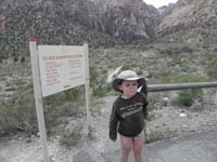 52-Kenny_at_the_trailhead-sign_says_5_miles_round-trip-wow_what_a_hiker-amazed_Mommy_and_Daddy